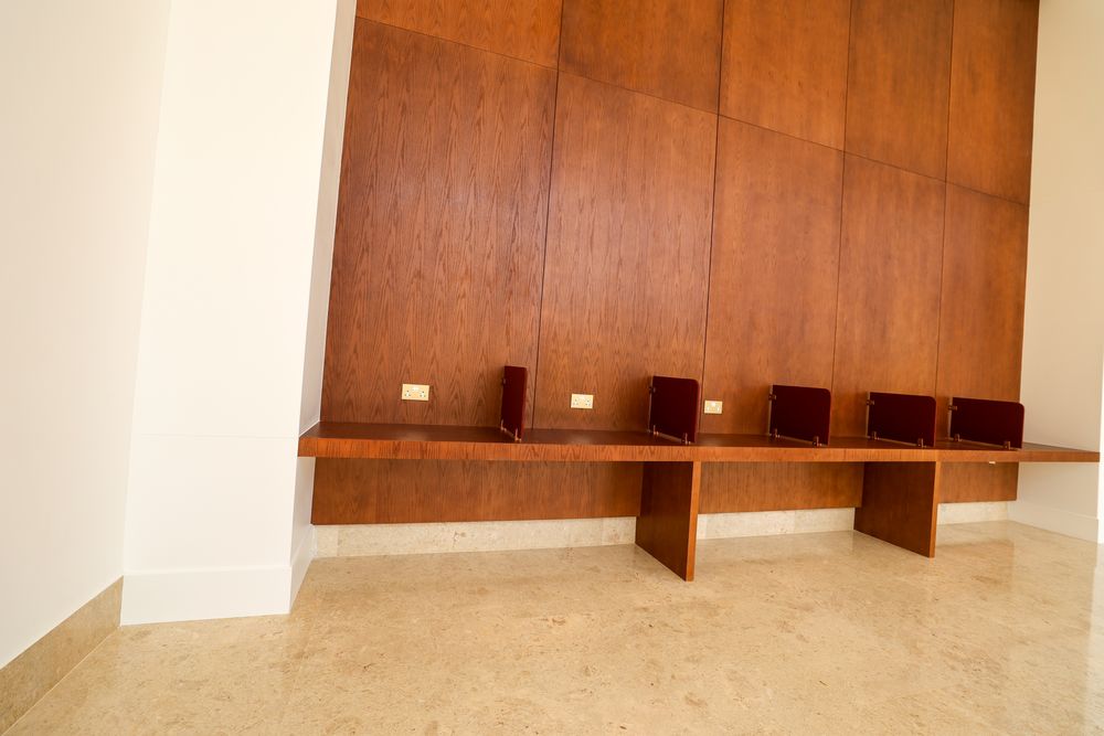 Oak-panelled wall and built-in bench with upholstered backs
