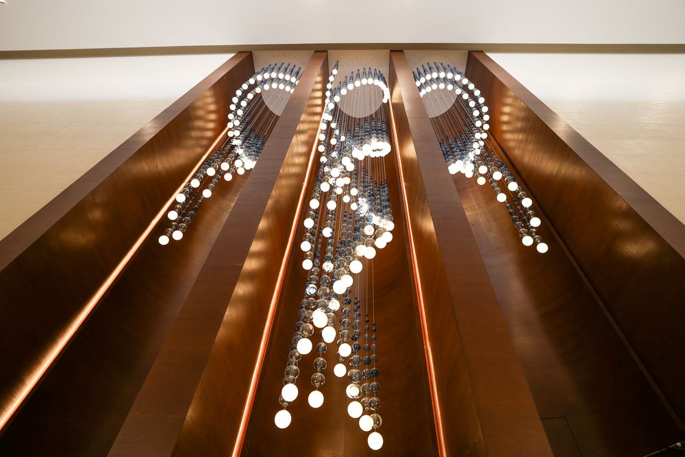 Suspended glass installation between timber coffers