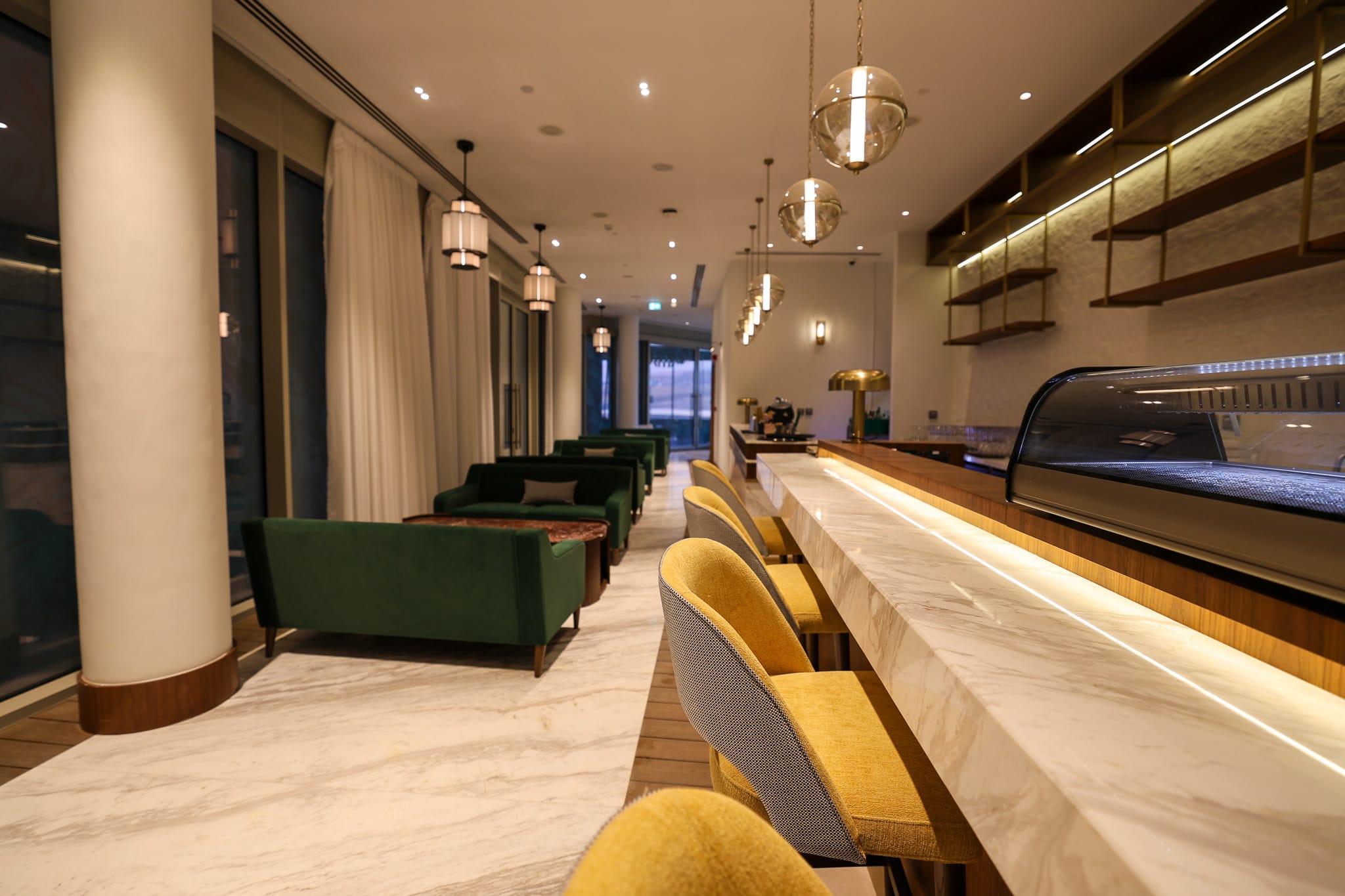 Marble bar, brass detailing & velvet seating